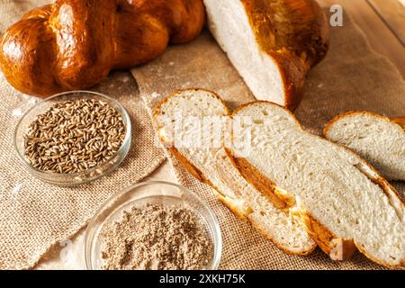 Pigtail bread and sliced bread on canvas cloth with ingredients in petri bowls. High quality photo Stock Photo