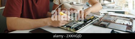 Colleagues Repairing Computer In Team Stock Photo