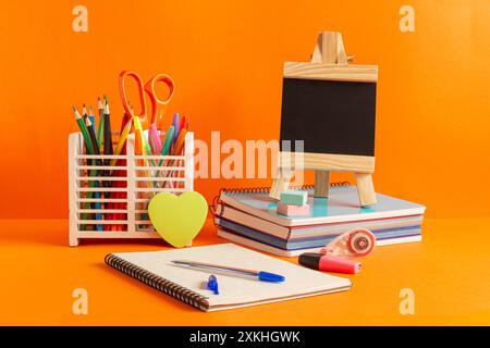 Essential supplies to have for a good return to school, to the institute. It is presented on an orange background. Stock Photo