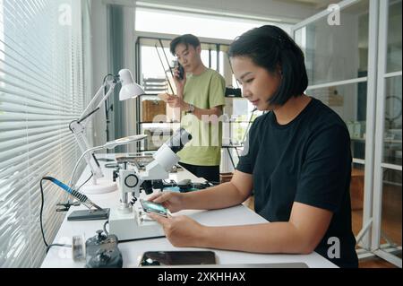 Colleagues Working In Computer Repair Service Stock Photo