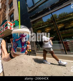 Free Slurpees are given away in a 7-Eleven store in New York on Thursday, July 11, 2024 (7-11, get it?),the self-proclaimed holiday, Free Slurpee Day! The popular icy, slushy, syrupy drinks are available in combinations, and the stores have stocked up with extra barrels of syrup to meet the expected demand. According to the meticulous figures kept by 7-Eleven they sell an average of 14 million Slurpees a month and over 150 million Slurpees a year.  (© Richard B. Levine) Stock Photo