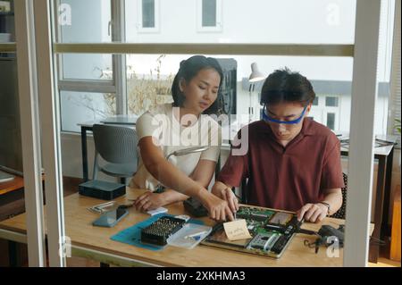 Colleagues Repairing Broken Laptop In Team Stock Photo