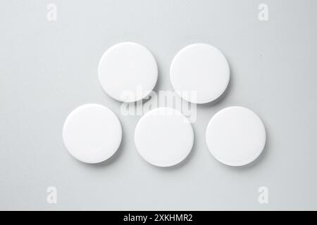 Blank white button badges on light background, flat lay. Mockup for design Stock Photo