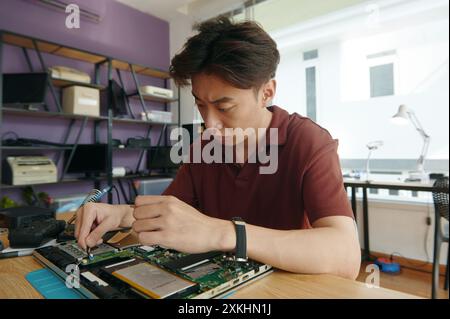 Master Working With Broken Laptop In Workshop Stock Photo