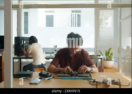 People Working In Computer Repair Service Stock Photo