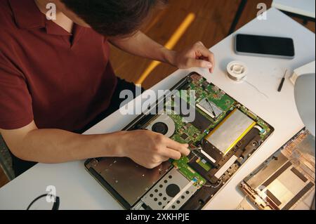 Repairman Working With Board Of Computer Stock Photo