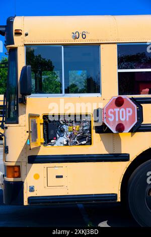 Vertical close-up shot of the driver’s side of the bus with the electronics panel open. Stock Photo