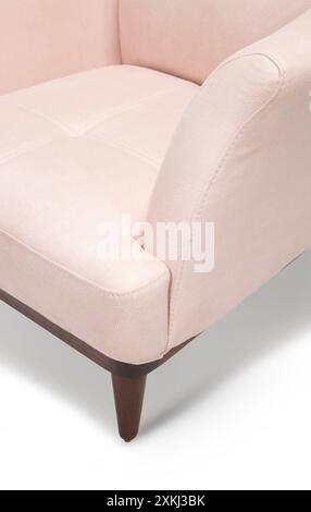 Elegant pastel pink armchair with wooden legs, perfect for modern living room decor. Stock Photo