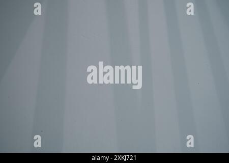 The shadow from the window falls on the white concrete texture of the old orange wall as a background. With space to copy. High quality photo Stock Photo