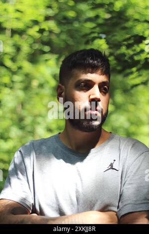 A vibrant image featuring a young tattooed man in sporting clothes, enjoying a sunny day in the city of Zurich. Perfect for themes related to urban li Stock Photo