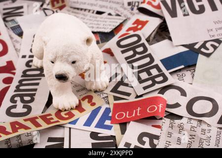 Polar bear on cut newspaper titles Stock Photo