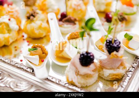 Elegant presentation of a gourmet appetizer selection, featuring bite-sized treats on a reflective surface. Stock Photo