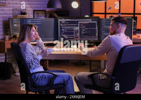 Young programmers working in office at night Stock Photo