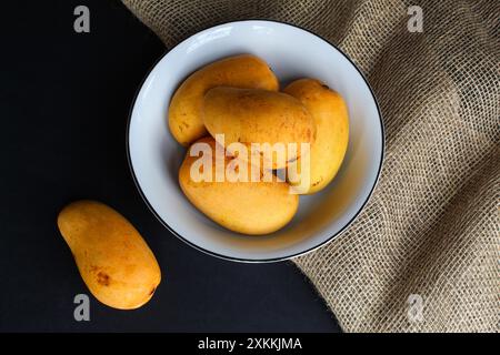 Bowl of mangoes on dark background Stock Photo