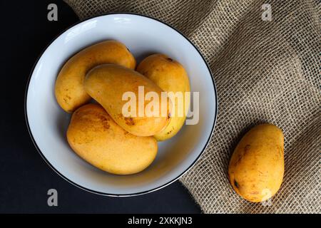 Bowl of mangoes on dark background Stock Photo