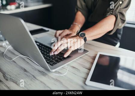 Mature, businesswoman and hands on laptop with typing for article review, editing blog post and copywriting. Freelancer, journalist and story research Stock Photo