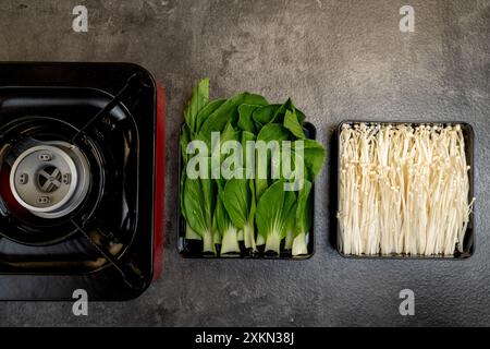 Three different types of vegetables are displayed on a countertop, including green beans, asparagus, and mushrooms Stock Photo