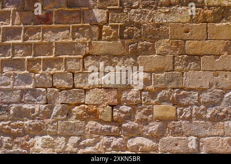 Rough stone wall background showcasing various shades and textures Stock Photo