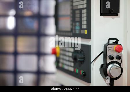 Manual pulse generator or remote handheld controller of CNC machine. Selective focus. Stock Photo