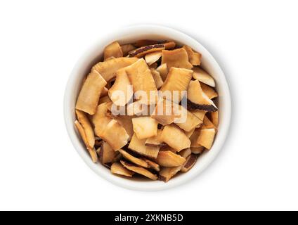 Bowl with sweet dried organic coconut pieces isolated on white background. Stock Photo