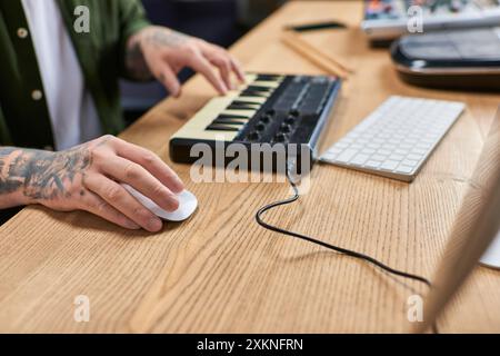 A close-up of an Asian mans hands working on music production in his studio. Stock Photo