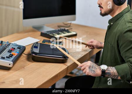 A handsome Asian man plays drums in a recording studio. Stock Photo