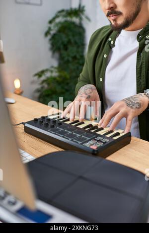 A close-up of a mans hands playing a MIDI keyboard in his studio. Stock Photo