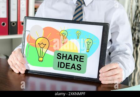 Share ideas concept shown by a businessman Stock Photo