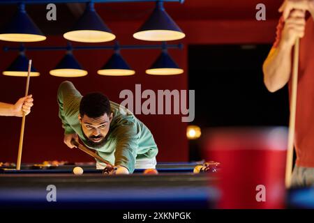 Friends play billiards in a stylishly lit room. Stock Photo