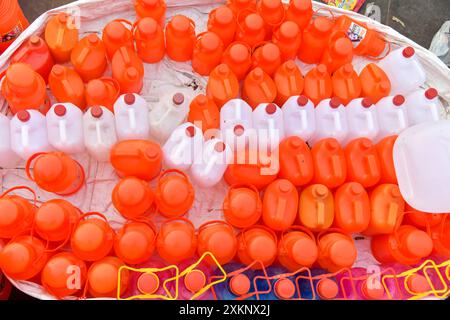 Different types of plastic cans are available to carry Ganga water in Haridwar. Stock Photo