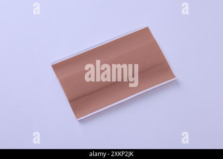 Single large bandage plaster close-up shot isolated on white background Stock Photo