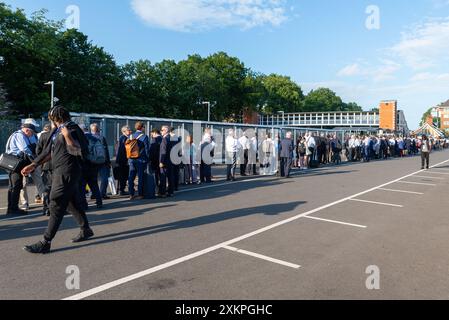 Queue of attendees of the Farnborough International Airshow 2024, UK, queuing to enter Farnborough Main railway station due to train cancellations Stock Photo