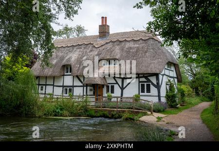 The Fulling mill, a picturesque  renovated 13th century thatched roof mill house on the river Arle in Alresford, Hampshire, England. Stock Photo