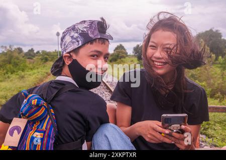 A mixed race family, domestic tourists, ride the bamboo train during the COVID - 19 pandemic. Battambang Province, Cambodia. © Kraig Lieb Stock Photo