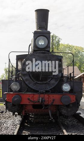 Vintage black steam locomotive is on Sortavala Central Railway Station on a sunny summer day, vertical photo, front view Stock Photo
