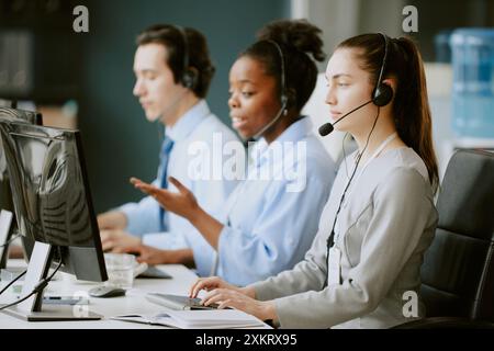 Team of young biracial operators having callsat work in office of modern company Stock Photo