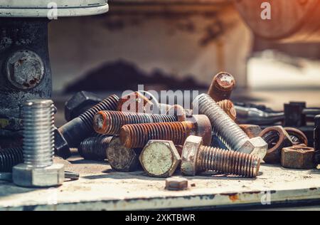 Assortment steel screws close-up. Set of bolts on blurred workshop background. Expendable hardware Stock Photo