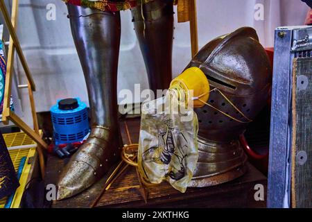 Medieval Armor and Modern Gear in Eclectic Storage Room Stock Photo