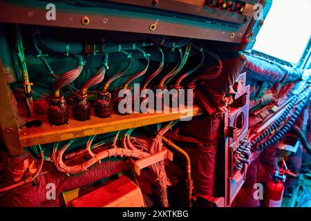 Intricate Electrical Components in Industrial Setting with Teal and Red Lighting Stock Photo
