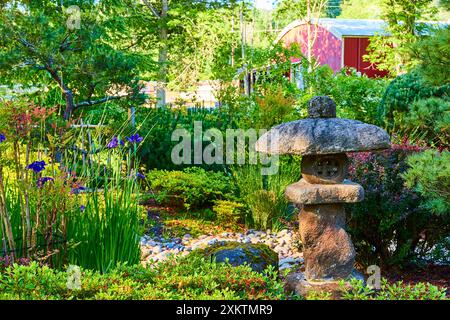 Serene Garden with Stone Lantern and Red Barn in Gresham Morning Light Stock Photo