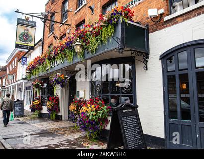 Charming exterior of the Royal Oak in Marlborough traditional English pub adorned with colorful flowers on the facade in a picturesque street setting. Stock Photo