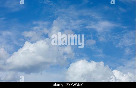 Cumulus clouds at blue sky at sunny day, Finland Stock Photo