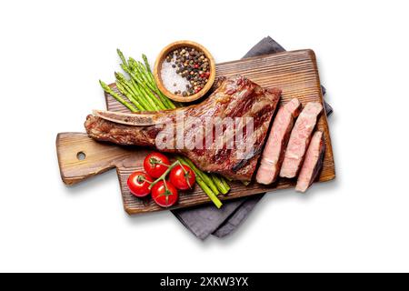 Medium rare grilled Tomahawk beef steak with asparagus. Flat lay. Isolated on white background Stock Photo