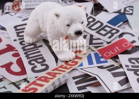 Polar bear on cut newspaper titles Stock Photo