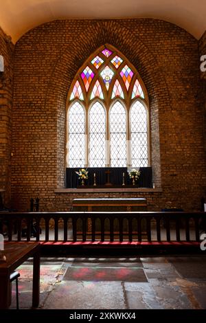 The altar and stained glass window inside St Audoen's church in Dublin, Ireland. Stock Photo
