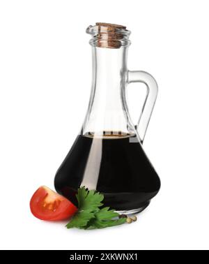 Balsamic vinegar in glass jug, parsley and tomato isolated on white Stock Photo