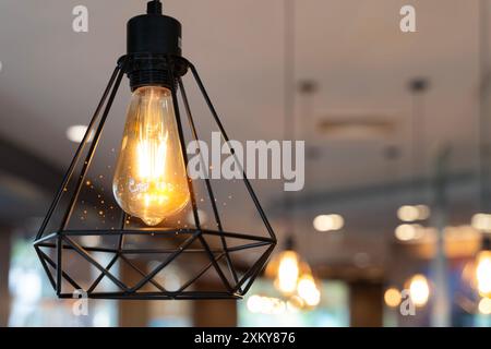 Luxury beautiful retro or vintage old style light bulb decor. Beautiful vintage luxury light bulb hanging decor glowing in dark. Retro filter effect s Stock Photo