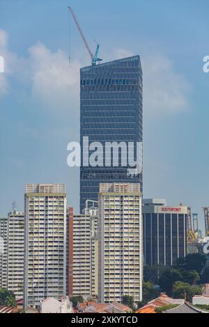 Massive skyscraper being built at Tanjong Pagar, the scale is different from the surrounding buildings. Singapore. Stock Photo