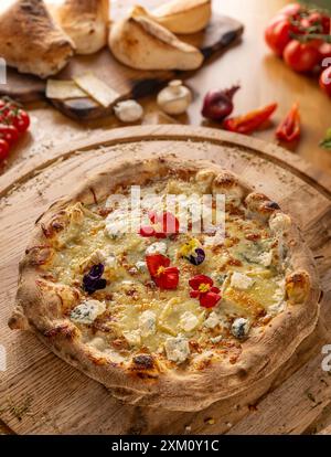 Flame grilled Italian four cheeses pizza served hot on a wooden board Stock Photo