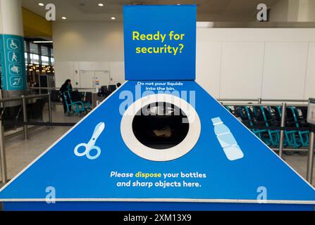 Bin for waste liquid, liquids, sharp items and sharps, displaying rules on items permitted in hand luggage & through security. Gatwick airport. UK. (138) Stock Photo